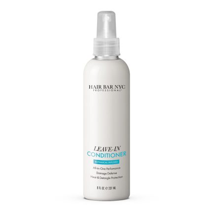 A white 8 fl oz (237 ml) bottle of Leave-in Conditioner by Hair Bar NYC features a spray nozzle and a label that reads "Botanica Infused," highlighting all-in-one performance, damage defense, and heat and detangle protection.