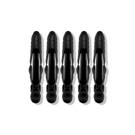 Five Professional Hair Clips, each black with “THE HAIR SANTO” printed in white, are arranged vertically and symmetrically against a solid black background. The clips are identical and evenly spaced side by side.