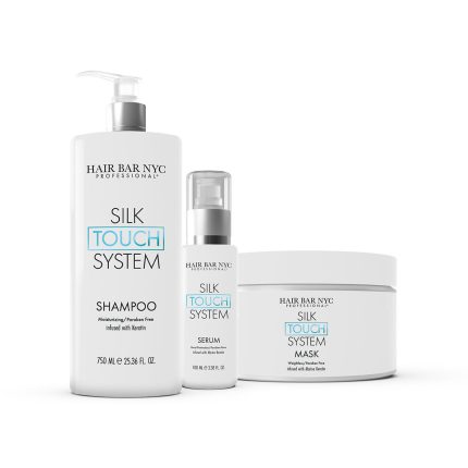 The Silk Touch System Duo Bundle is displayed, featuring a tall shampoo pump bottle, a smaller serum pump bottle, and a wide mask jar. Packaging is white with black and light blue text.