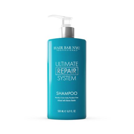 A turquoise bottle of Ultimate System Repair Shampoo with a white pump dispenser. Features keratin and marine keratin infusion, free from colorants, sulfates, and parabens. Contains 500 mL (16.9 fl oz).