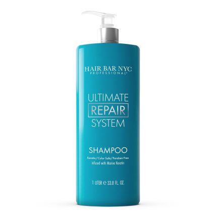 A large teal 1-liter (33.8 fl oz) bottle of Ultimate System Repair Shampoo with a white pump stands upright against a white background. The label features keratin, color safe, paraben free, and marine keratin infusion.