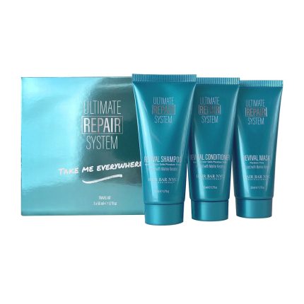 The Ultimate Repair System Travel Kit includes three teal 3.15 fl oz/97 mL tubes—Revival Shampoo, Conditioner, and Mask—with white and gold text. The box features “Take Me Everywhere” in pink script.