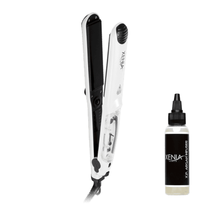 A Ceramic Steam Flat Iron 1.25” in white and black, with a transparent compartment, stands upright next to a small Xenia X.P. Argan Infuser bottle on a plain white background, highlighting both the sleek styling tool and hair product.